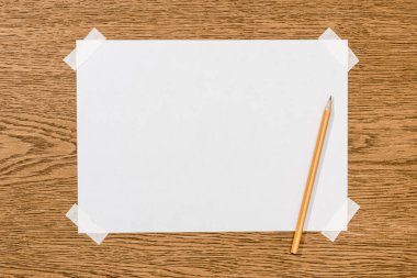 top view of blank white paper and graphite pencil on wooden table  clipart