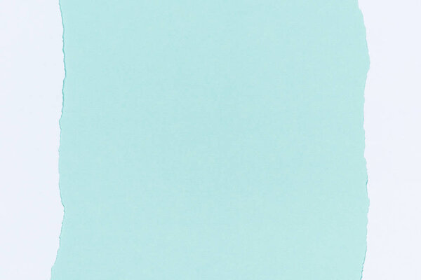 top view of ripped empty white paper on turquoise 