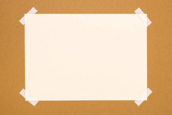 top view of blank white paper on beige 