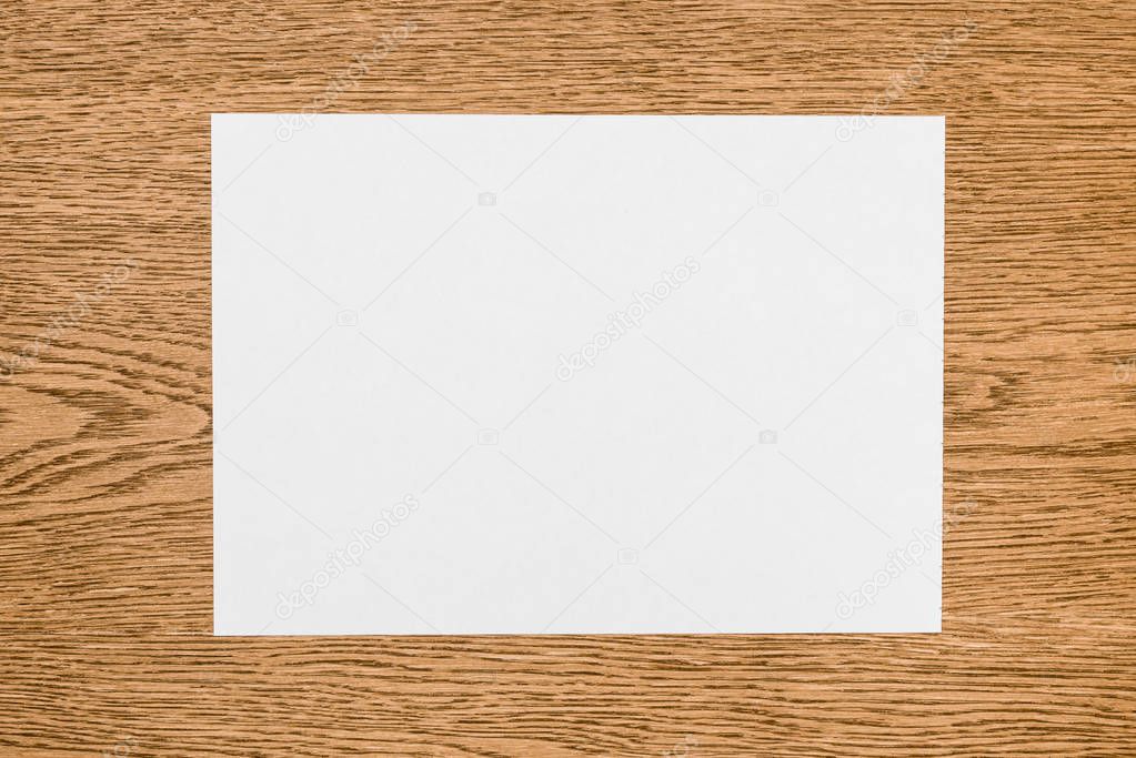 elevated view of empty white paper on wooden table 