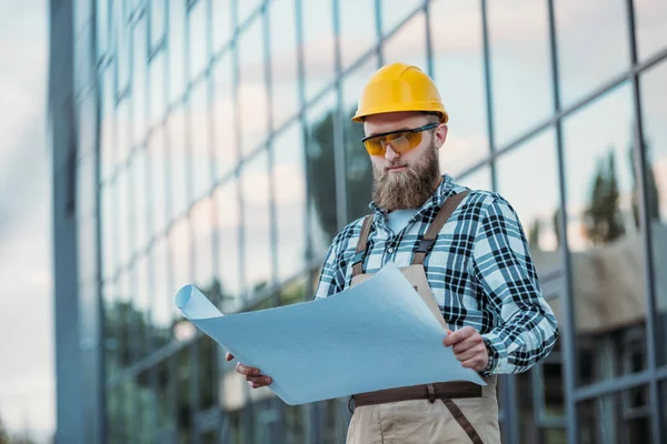 Οικοδοµές Στην Προστατευτική Googles Και Hardhat Βλέπουν Blueprint — Φωτογραφία Αρχείου