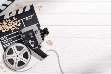 düz lay clapper kurulu, film karesi, retro kamera ve beyaz ahşap yüzeyde düzenlenen sinema biletleri ile