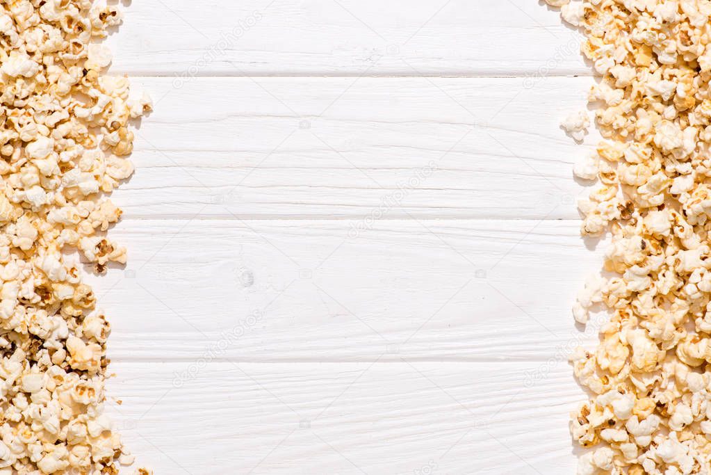 full frame of arranged popcorn on white wooden tabletop