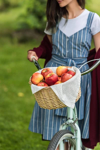 Partial View Young Woman Wicker Basket Full Fresh Apples Bicycle — Free Stock Photo