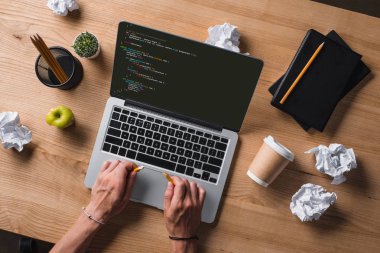 cropped shot of businessman breaking pencil while looking at code on screen at workplace clipart