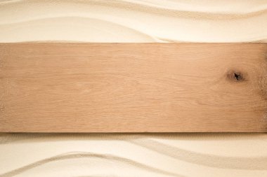 top view of blank wooden plank on sandy surface clipart