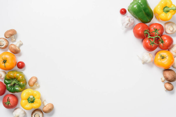 top view of ripe bell peppers, tomatoes and mushrooms isolated on white