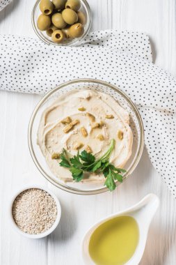 maydanoz, zeytin ve baharat humus üstten görünüm ahşap masa üzerinde