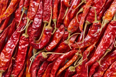 full frame of red dried chili peppers as background