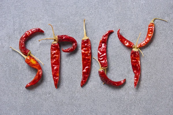 Top View Dried Chili Peppers Arranged Spicy Lettering Grey Tabletop — Stock Photo, Image