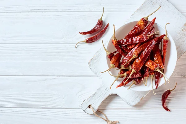 Top View Dried Cayenne Peppers Bowl White Cutting Board Wooden — Stock Photo, Image