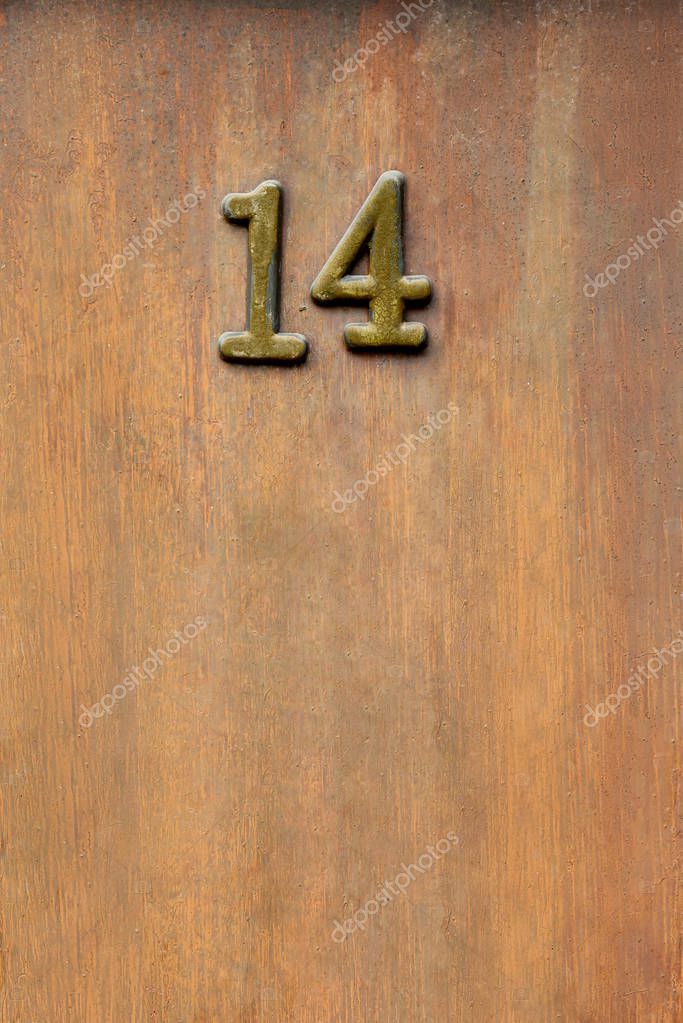 Close up view of 14 sign on wooden door