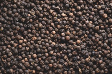full frame view of dried aromatic peppercorns background clipart