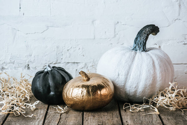 still life of various painted halloween pumpkins on wooden surface