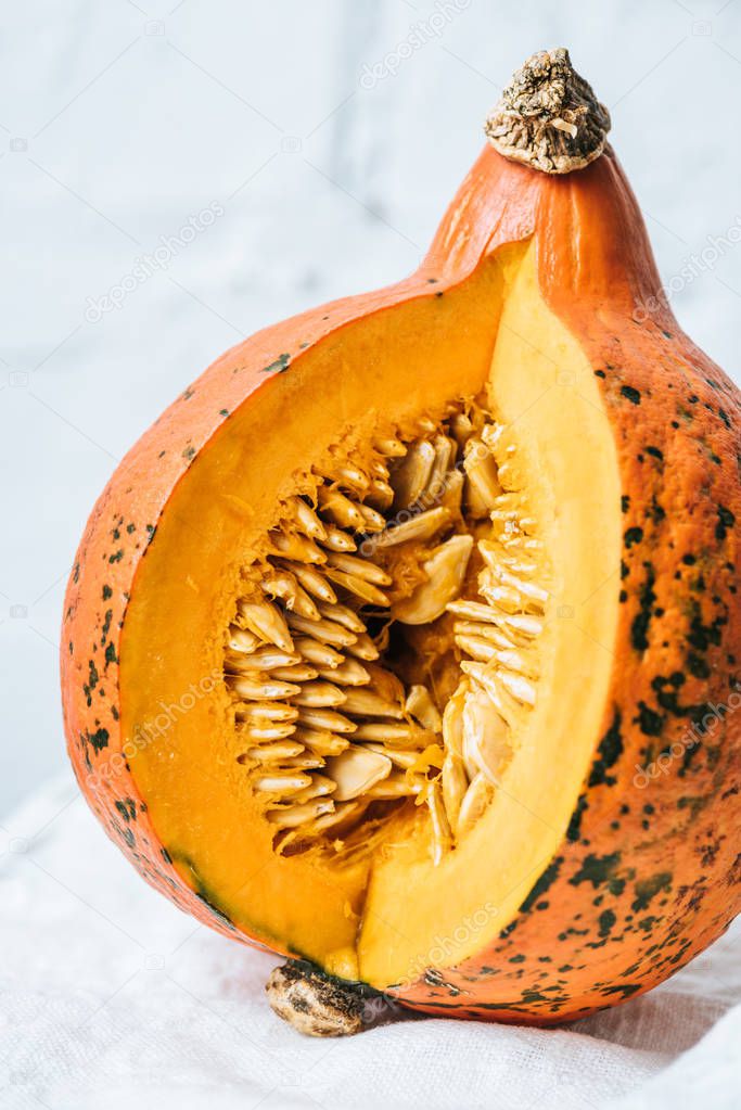 close up view of ripe pumpkin on white brick wall background
