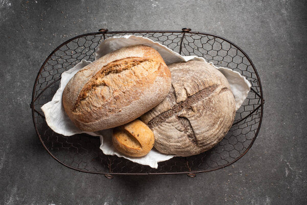 top view of ciabatta bread in basket on grey backdrop