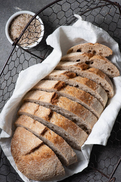 flat lay with cut loaf of bread on grey tabletop