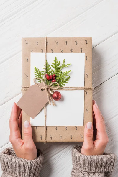 Imagen Recortada Mujer Con Caja Regalo Navidad Decorada Mesa Madera — Foto de Stock