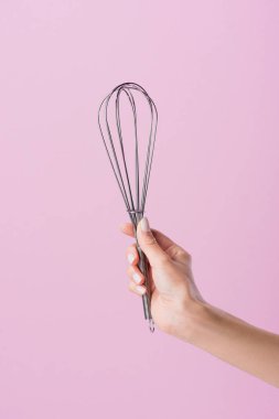 cropped shot of woman holding whisk isolated on pink clipart