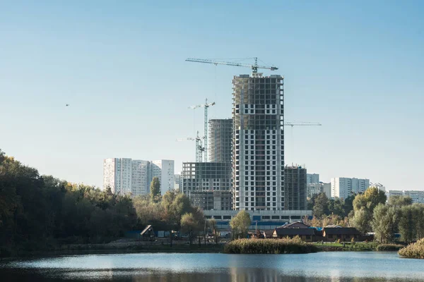 modern buildings and lake in city in autumn