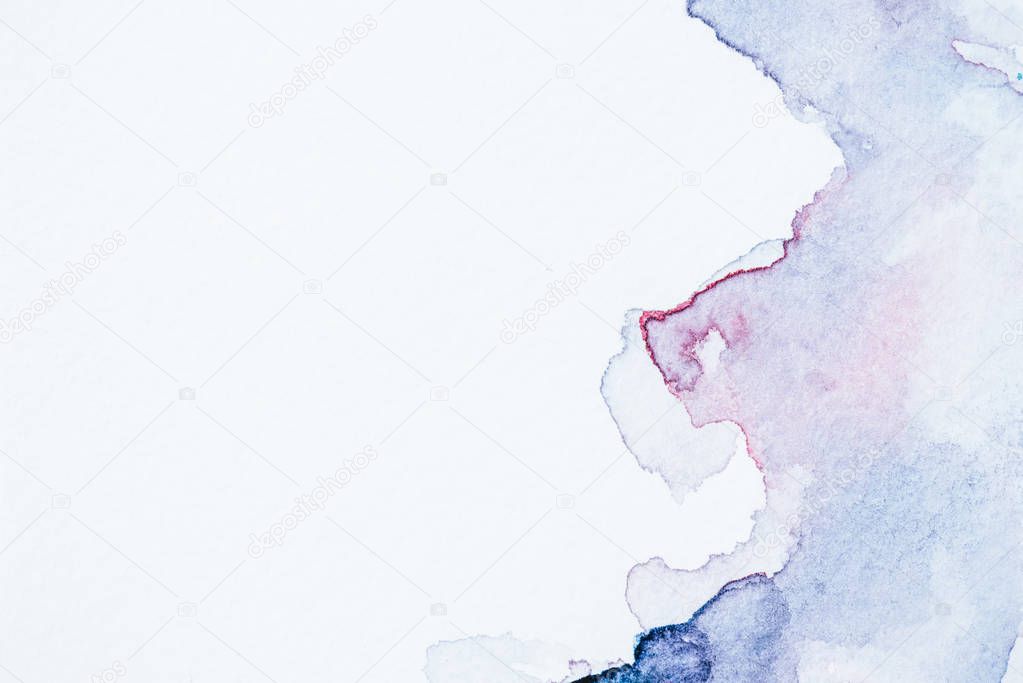 creative background with blue and purple watercolor blots on white paper