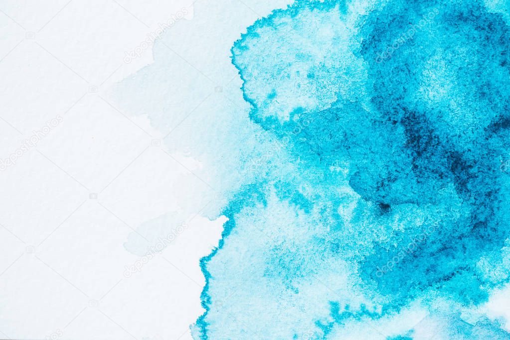 abstract bright blue and turquoise paint blots on paper
