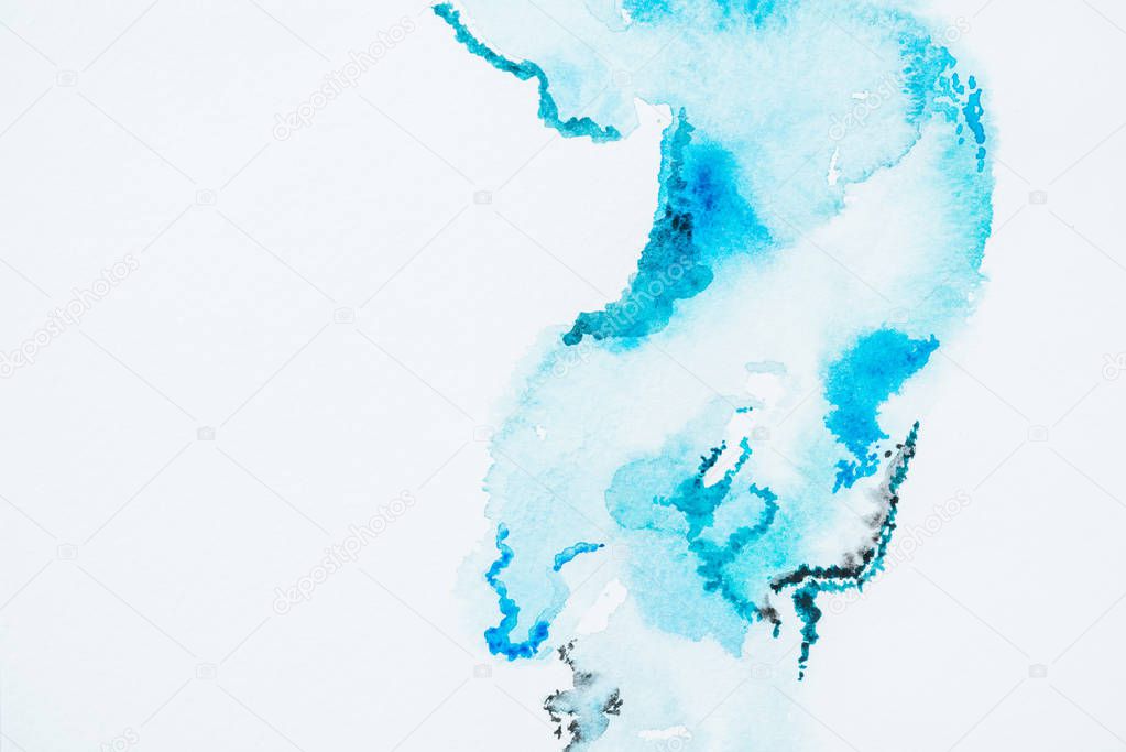 abstract bright turquoise paint blots on white paper