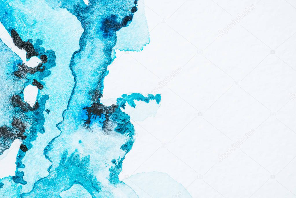 abstract bright turquoise watercolor paint blots on paper