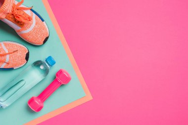 Flat lay with sport equipment on pink background clipart