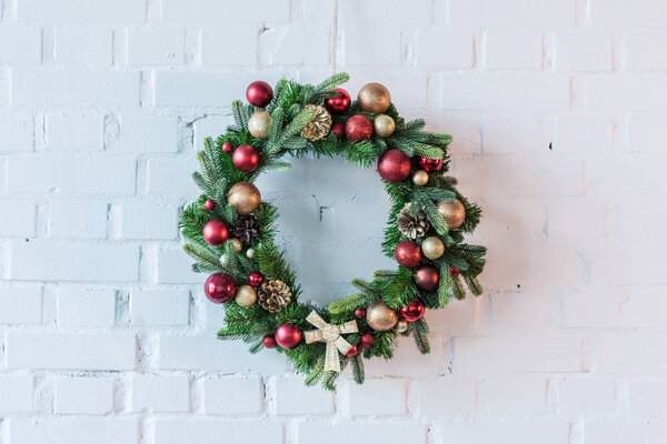 Christmar wreath on the background of white brick wall