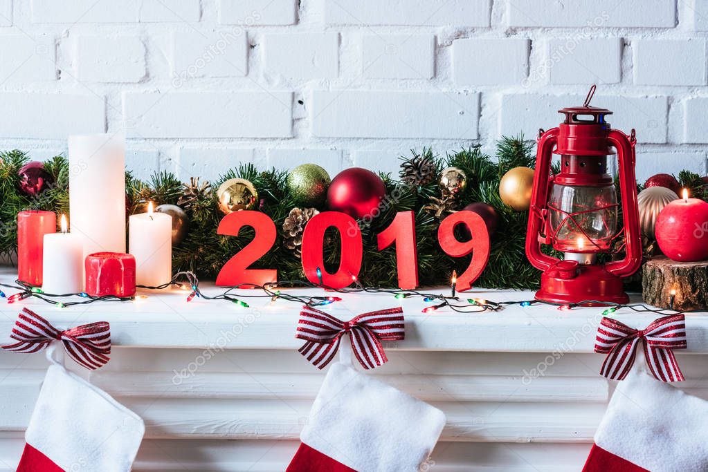 2019 year sign with Christmas wreath, candles and socks 