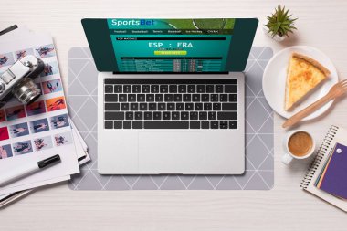 office desk with laptop with sports betting website on screen, flat lay clipart