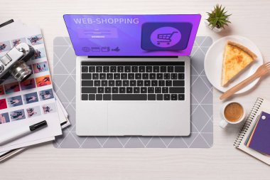 office desk with laptop with shopping website on screen, flat lay clipart