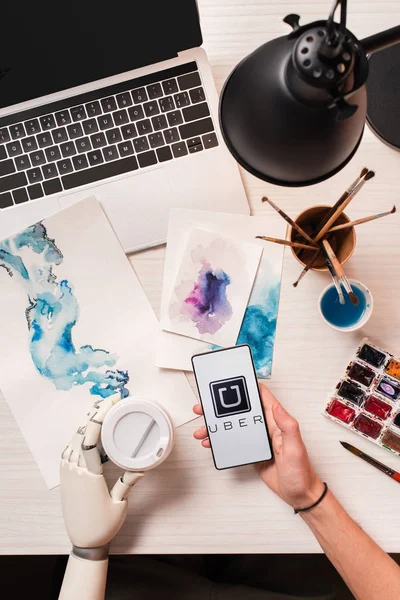 Cropped View Designer Office Desk Robot Hand Holding Smartphone Uber — Stock Photo, Image