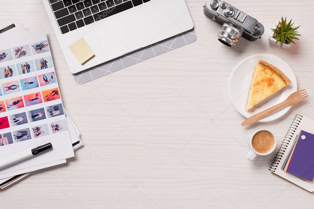 Office desk with laptop, designer supplies and copy space, flat lay