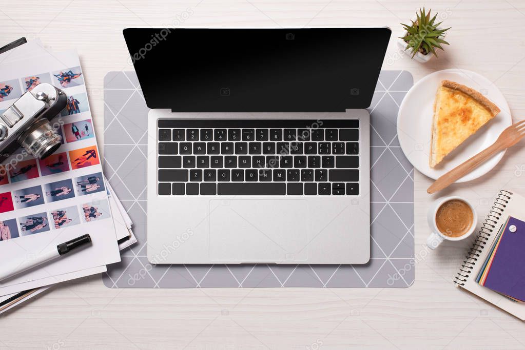 office desk with laptop with blank screen, flat lay