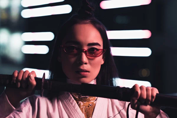 Attractive Asian Girl White Kimono Showing Sword Street Neon Light — Free Stock Photo