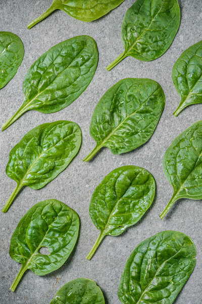 Flat lay of organic and wet spinach leaves 