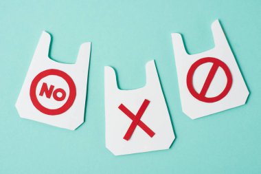 Paper models of packets with no and prohibition signs on blue background