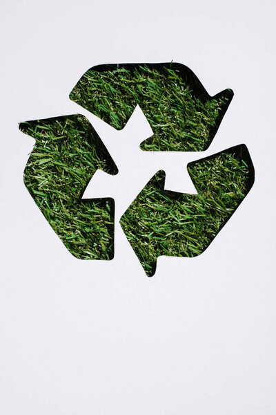 Top view of trash recycle sign with grass patern isolated on white