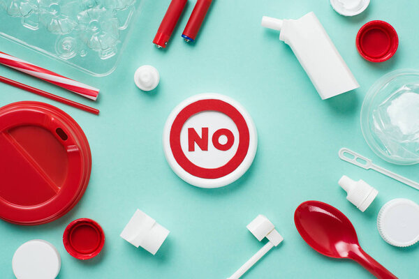 Top view of no sign and disposable plactic wares on blue background