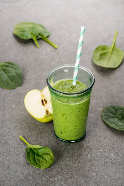 Green apple and healthy organic smoothie in glass with straw 