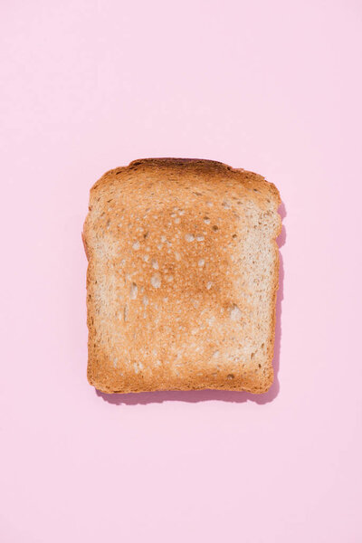 top view of crunchy toast on pink surface