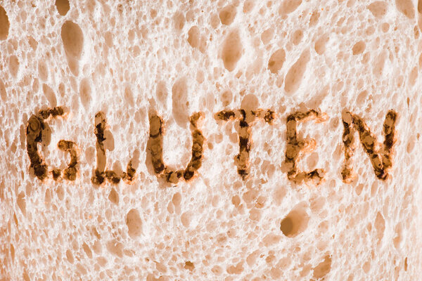 close-up shot of slice of bread with burned gluten sign