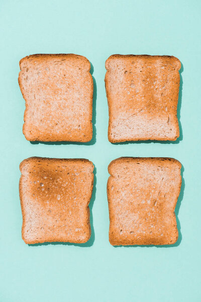 top view of assembled crunchy toasts on blue surface