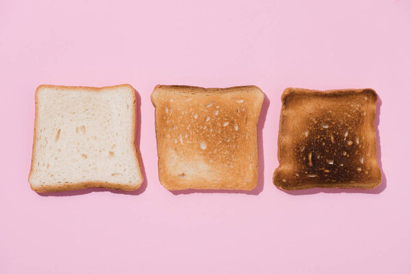 top view of toasts in various roast stages on pink surface