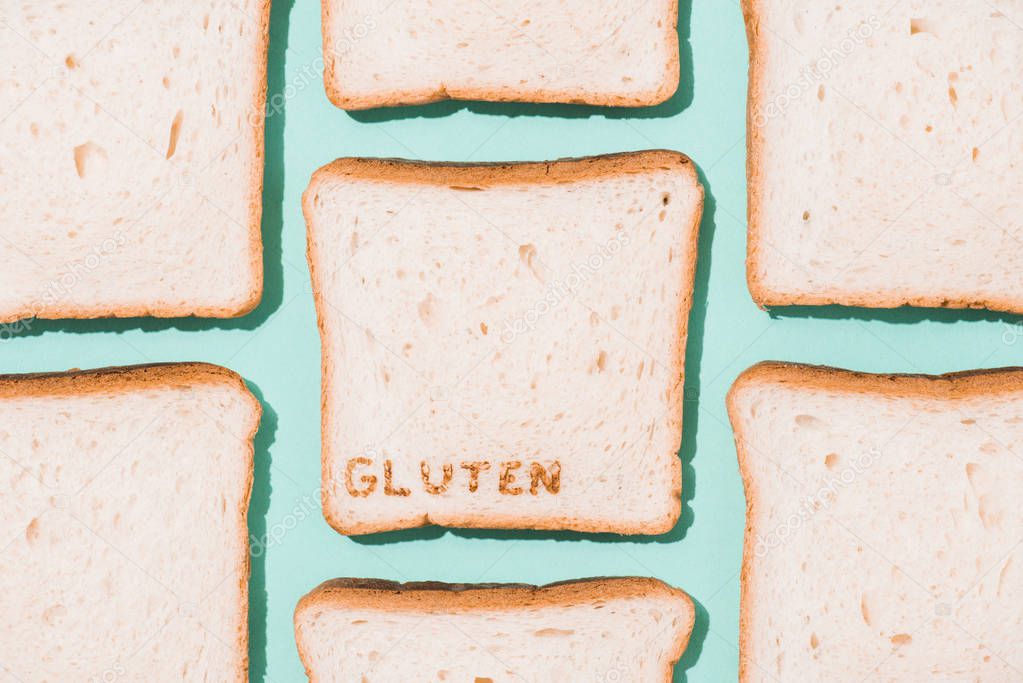 top view of bread slices with gluten sign on blue surface