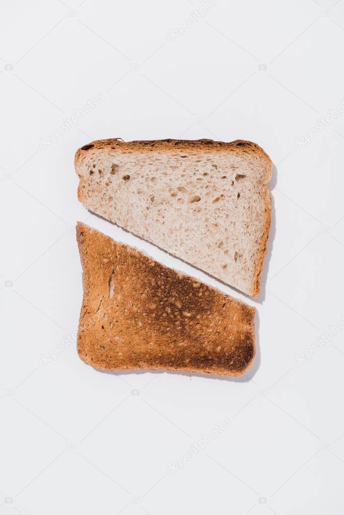 top view of slice of bread with roasted half on white surface