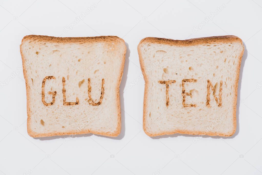 top view of slices of bread with burned gluten sign on white surface