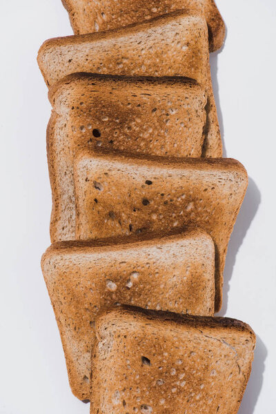top view of stack of crunchy toasts on white tabletop